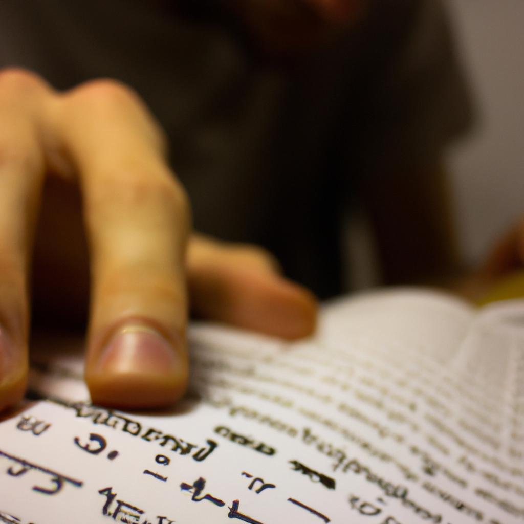 Person reading Hebrew text, studying